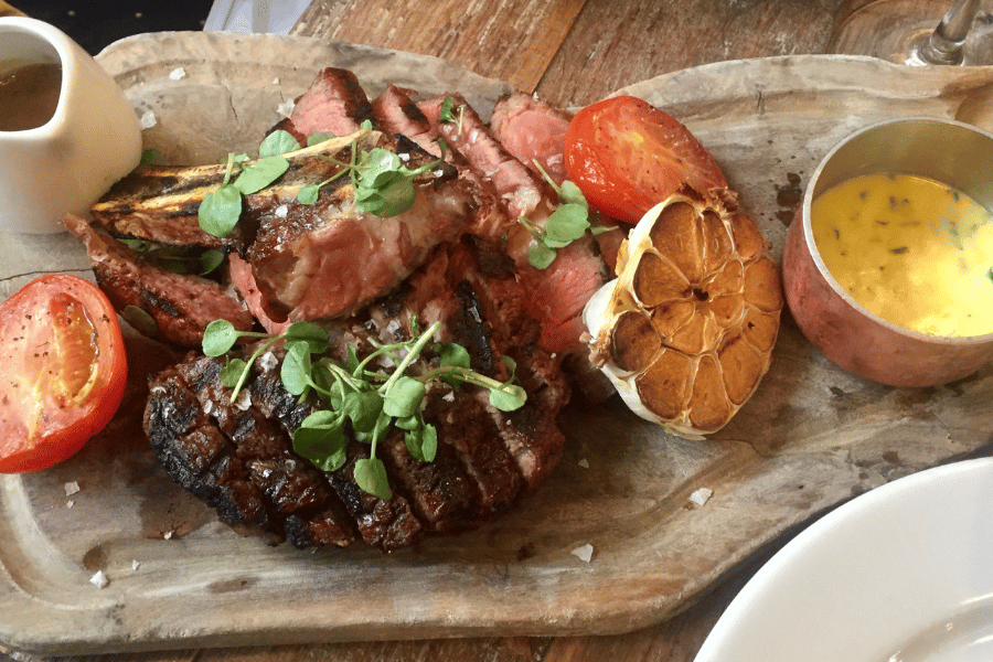 lobster and steak on a wood board
