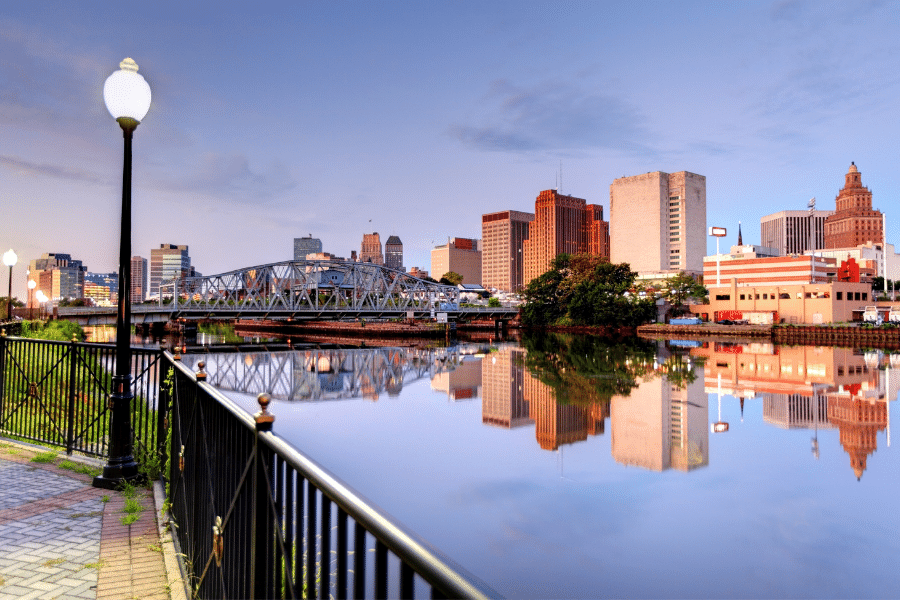 Newark, NJ waterfront park with buildings and a bridge  