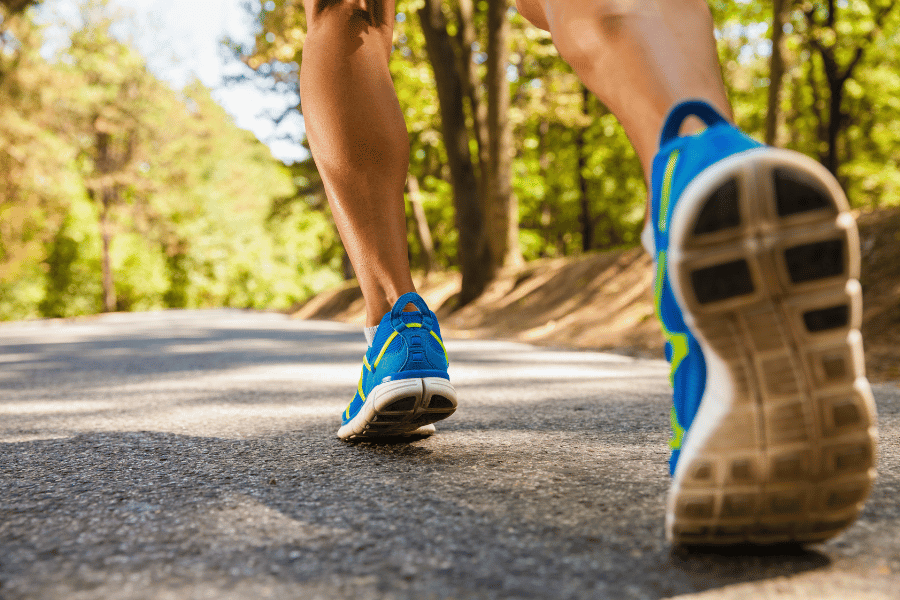 running and walking on trail surrounded by trees