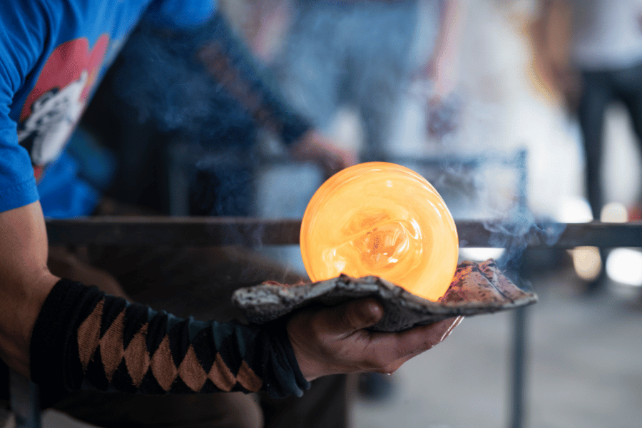 Person glass blowing making a bowl 
