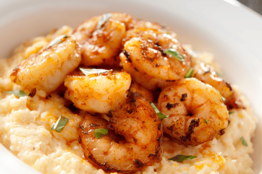 White plate of delicious shrimp and grits 