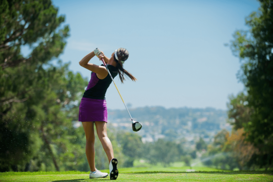 woman playing golf on a golf course