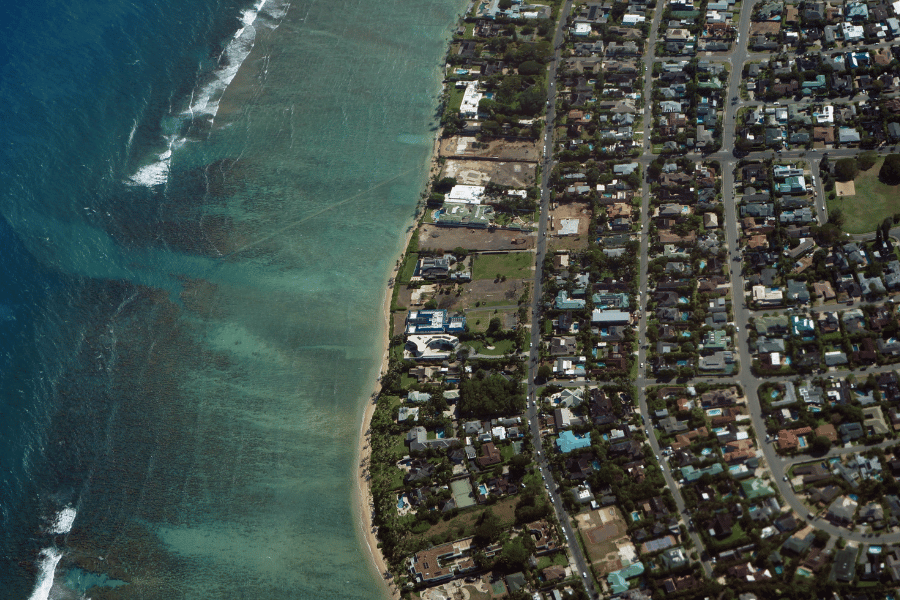 Aerial view of Kahala in Honolulu, HI with buildings and blue water 