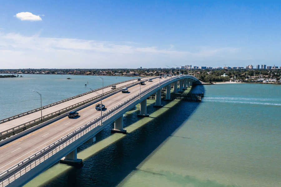 Cars driving over the Marco Island Bridge on a beautiful sunny day