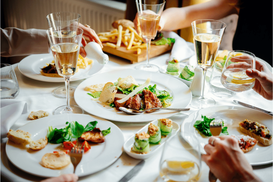 Restaurant with diners eating together at a table