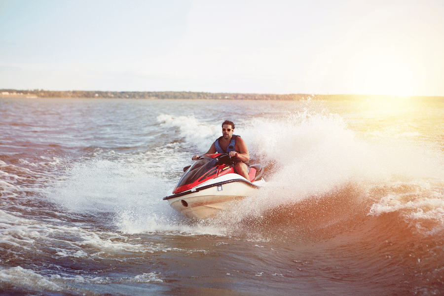 Image of a middle aged man on a jetski with crystal clear blue waters