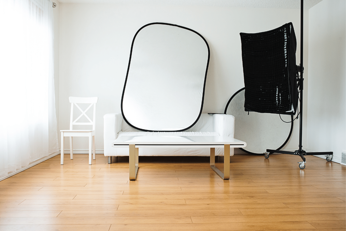 Chair, reflector, lights, camera, tripod all the things you need to create a photography studio at home