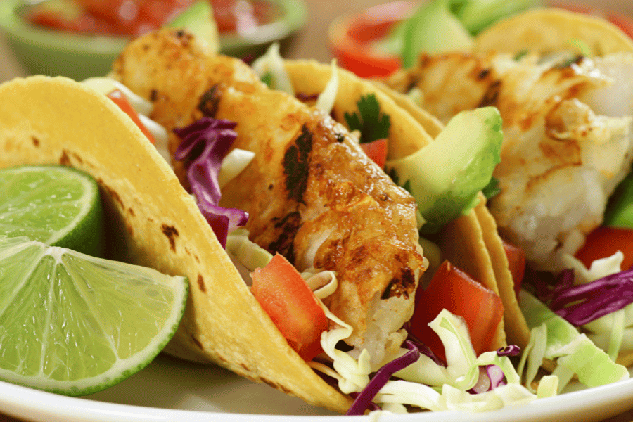 delicious fish tacos with lime wedges 