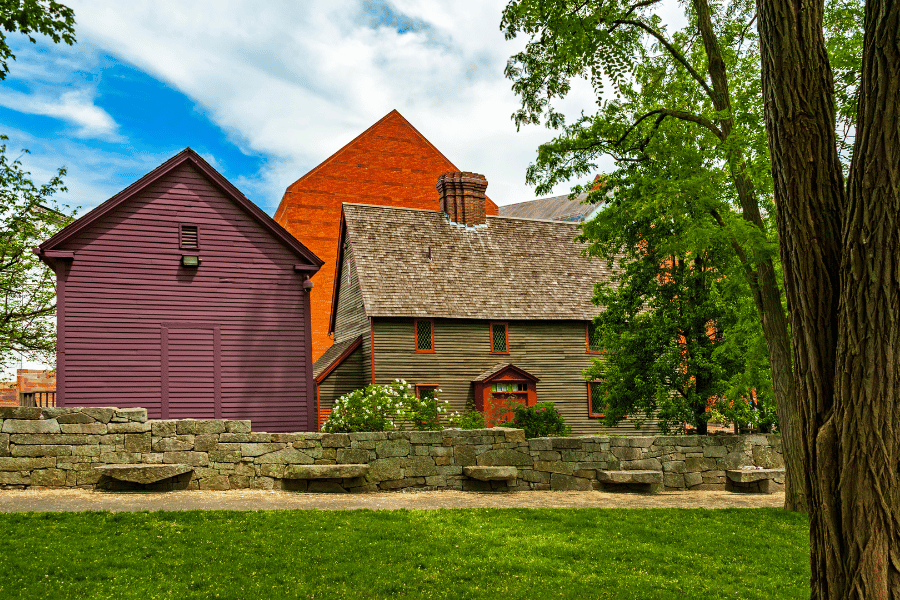 Salem Witch Trials memorial on a sunny day with a stone fence 