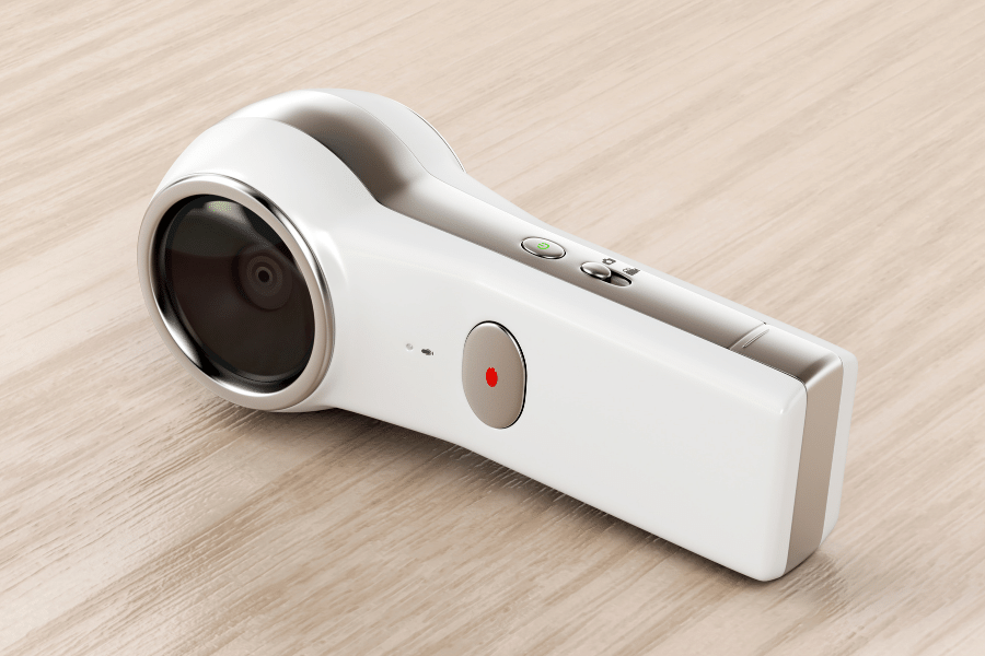 white 360-degree camera on wooden background