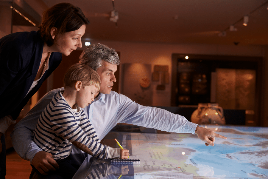 A family looks at a map at a museum 