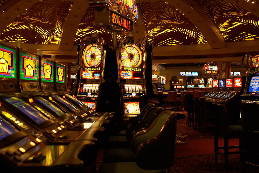 Inside a colorful casino with slot machines at night 