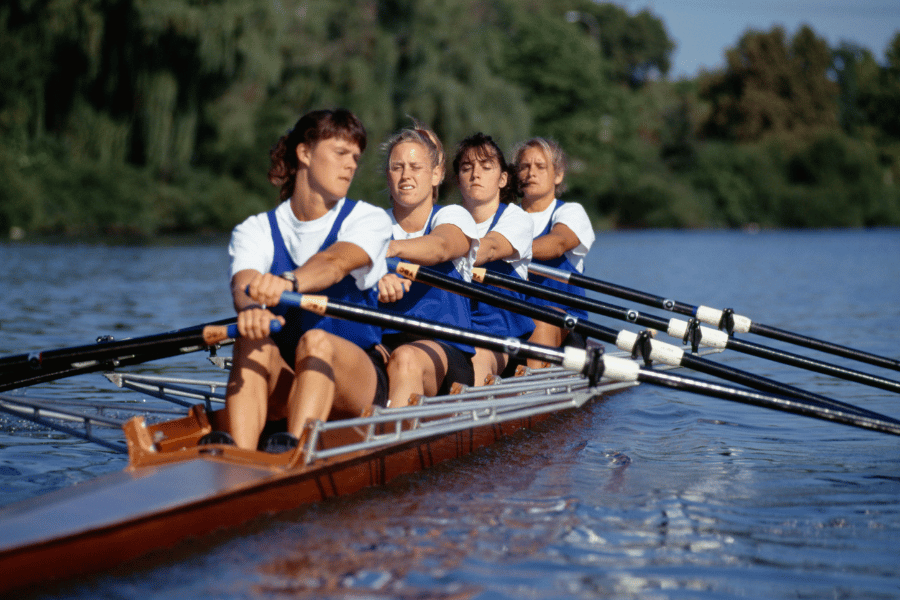rowing team rowing on a lake 