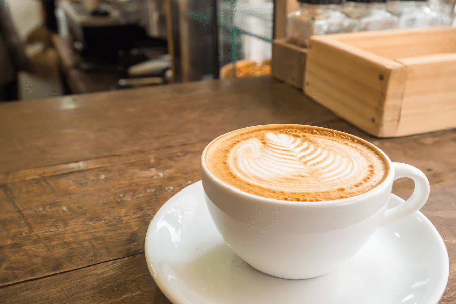 Cup of coffee on a wood table in a relaxing coffee shop 