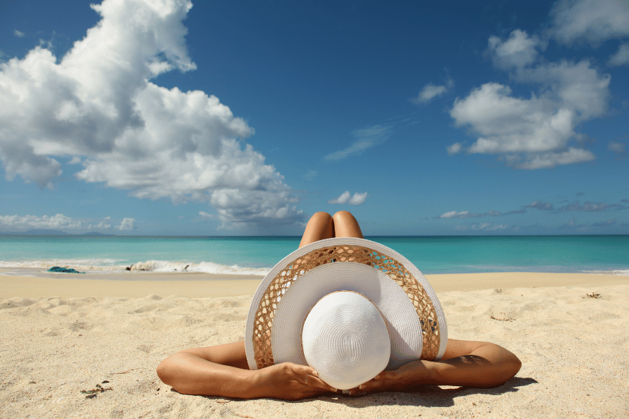 relaxing on the beach sunbathing hat sand ocean