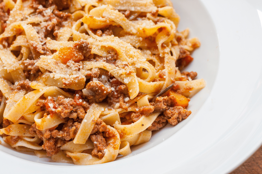 Bolognese pasta in a white bowl