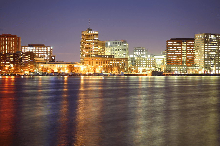 the city of Cambridge, MA at night with buildings near the water
