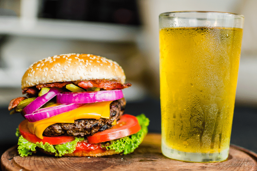 A tasty burger and cold beer in a glass 