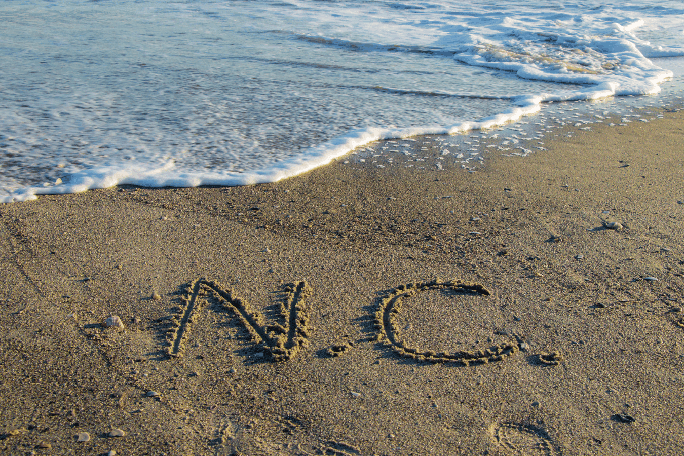 The North Carolina NC written in the sand on the beach