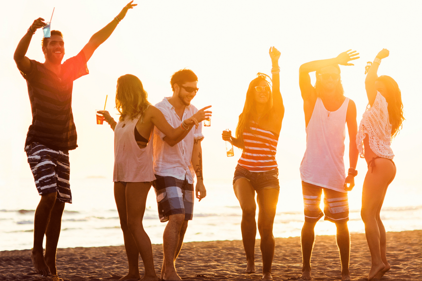 Beach goers having a great time on the beach celebrating friendship