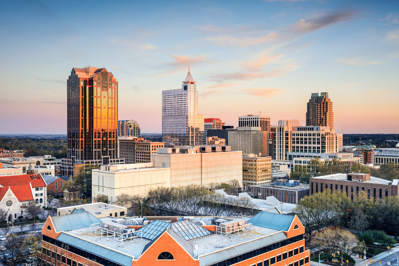 A photo of the downtown Raleigh skyline at sunset