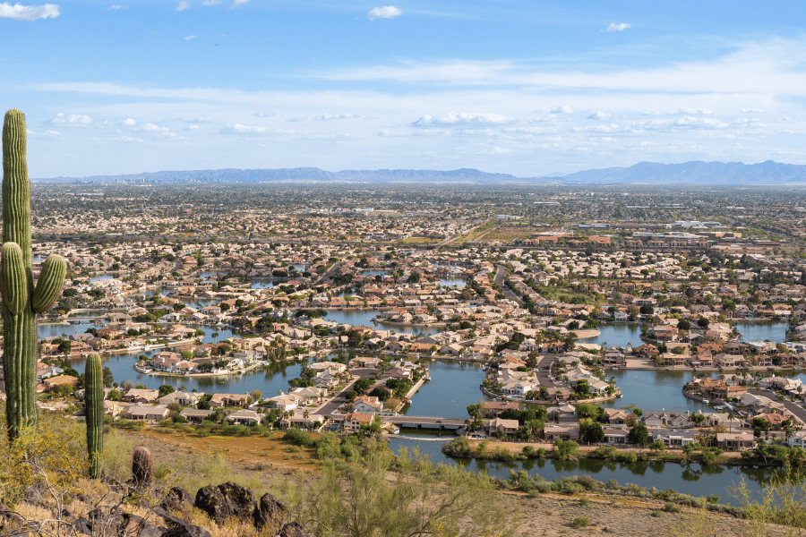 Mountain view of Chandler, AZ with cacti, houses, and lakes on a sunny day