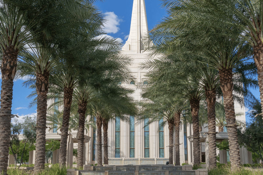 The Gilbert Arizona Temple with palm trees on a sunny day