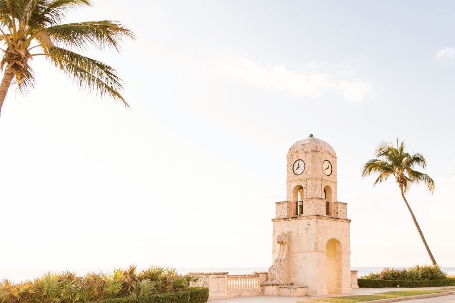 Clocktower in Palm Beach near palm trees 