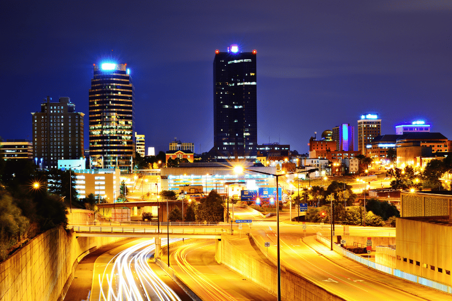 downtown knoxville at night with bright lights and cars 