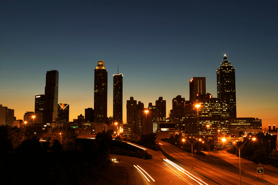 Atlanta, GA skyline at dusk lights on highway and in buildings