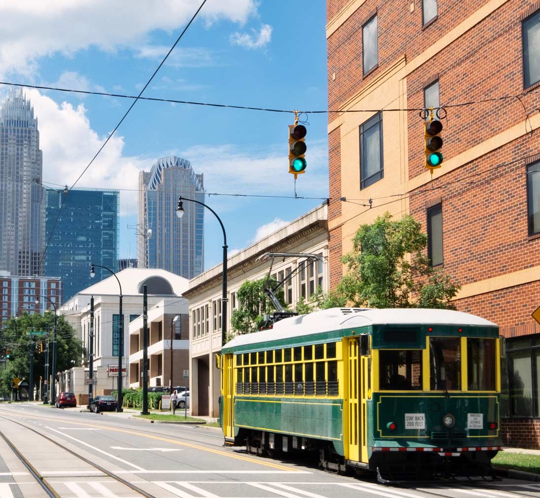 Charlotte NC skyline with the Q city trolley in the foreground - Fun things to do in Charlotte NC