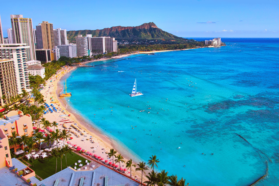 Waikiki Beach bright blue water and high-rise buildings in Honolulu, Hawaii