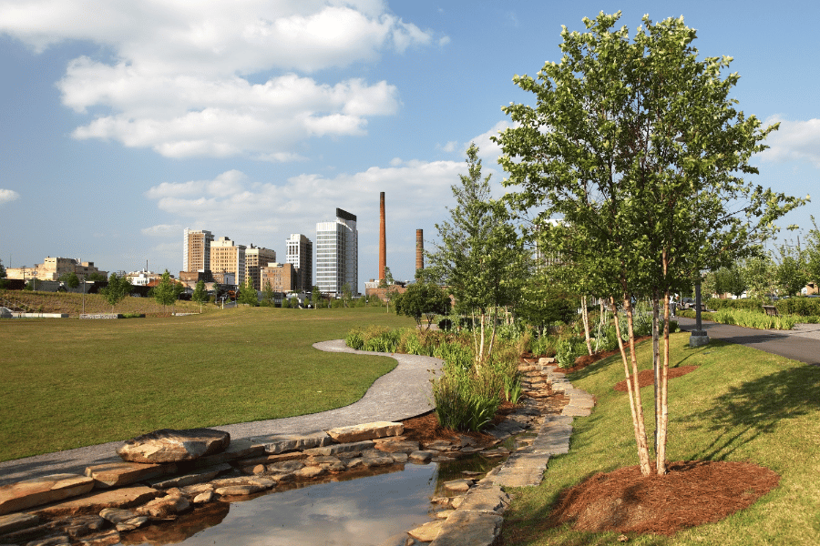 park in Birmingham, AL with trees and a pond