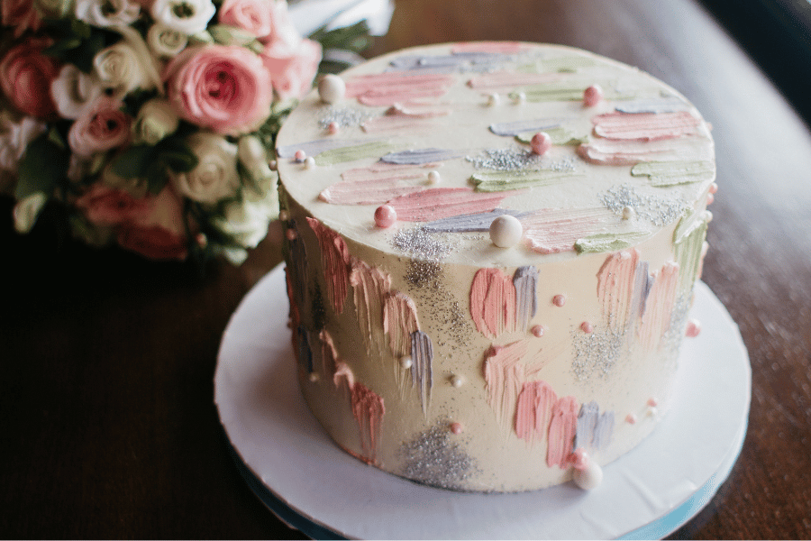 beautiful decorated cake with pink and purple icing and flowers 