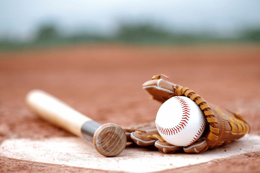 Baseball bat and glove on baseball field