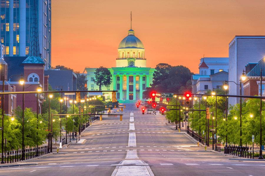 Montgomery, Alabama during the sunset with orange sky and street lights