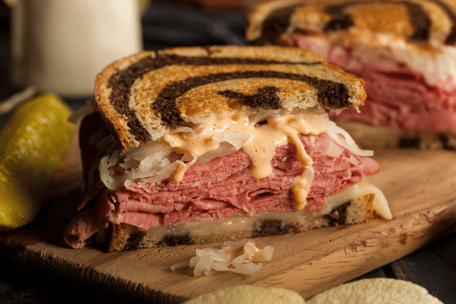 reuben sandwich on rye bread with pickle 