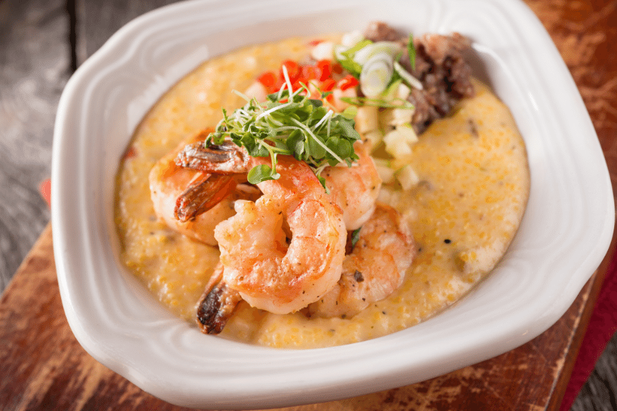 bowl of shrimp and grits on a wood table