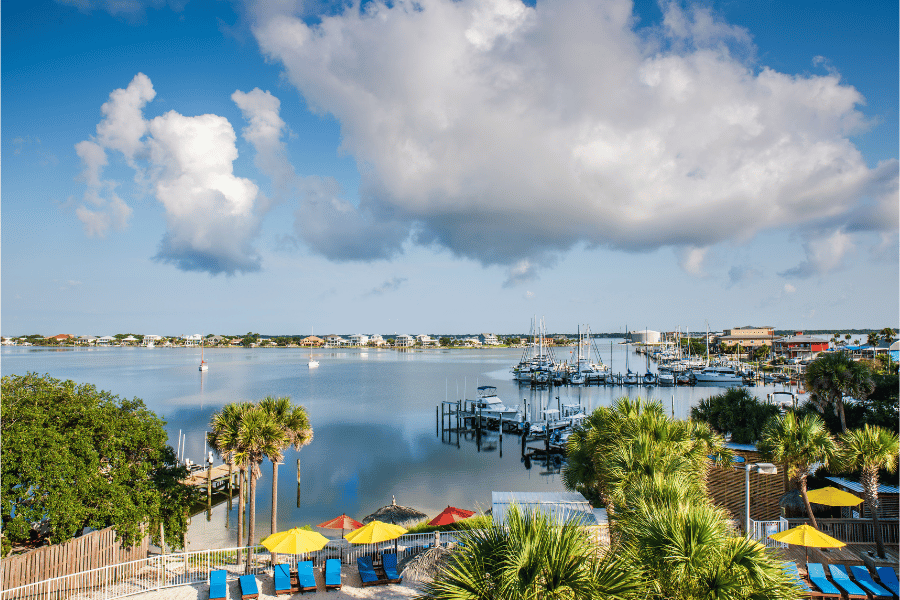 Clear Skies in Pensacola near the water with boats and palm trees