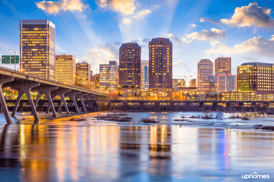 A sunrise in Virginia happening behind buildings with a waterfront view