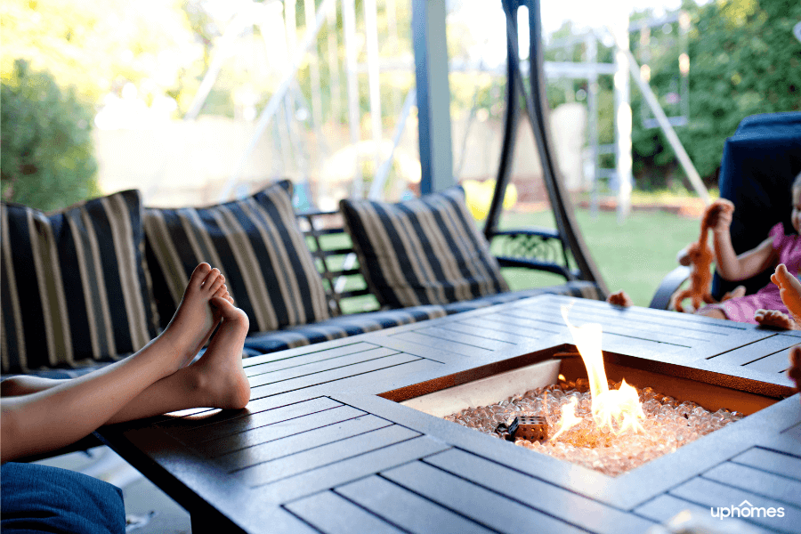 Fire pit in backyard with feet up relaxing and enjoying a cozy, comfortable backyard