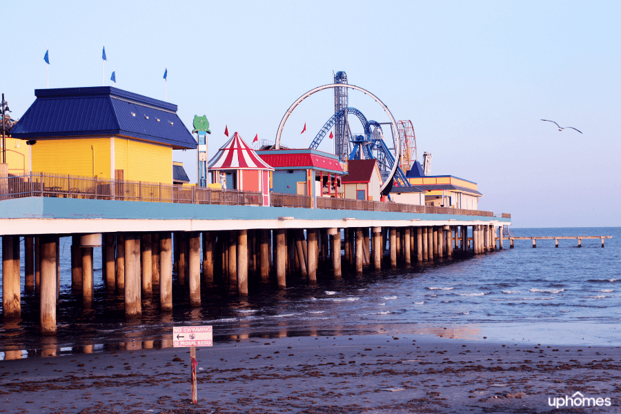 Galveston TX pier on a sunny day with ferris wheel in background Galveston TX pier on a sunny day with ferris wheel in background