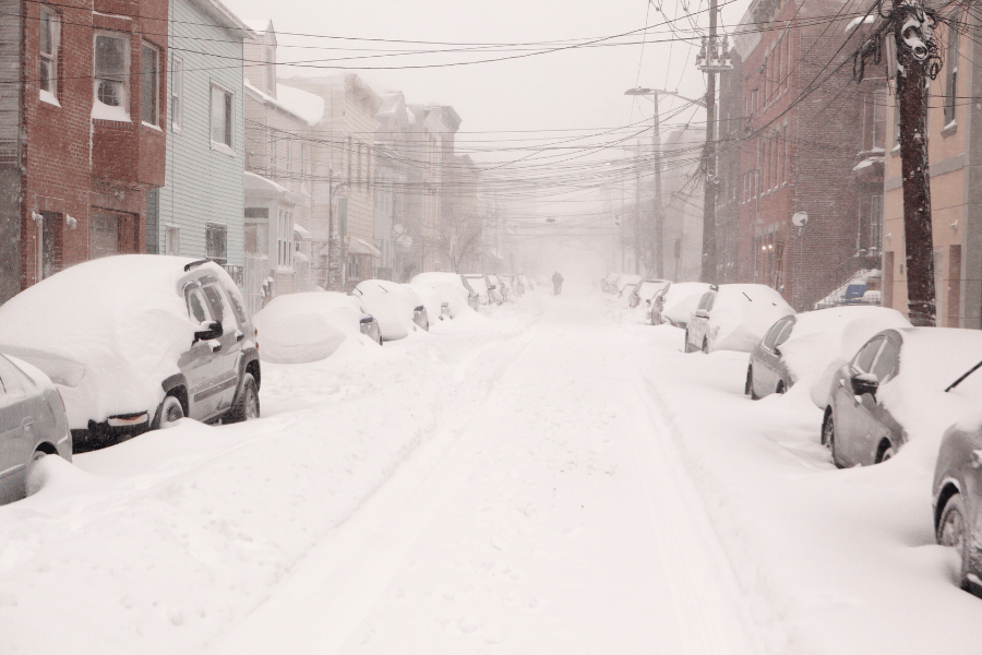 Snowy Street Image of a snowy street with cars on each side