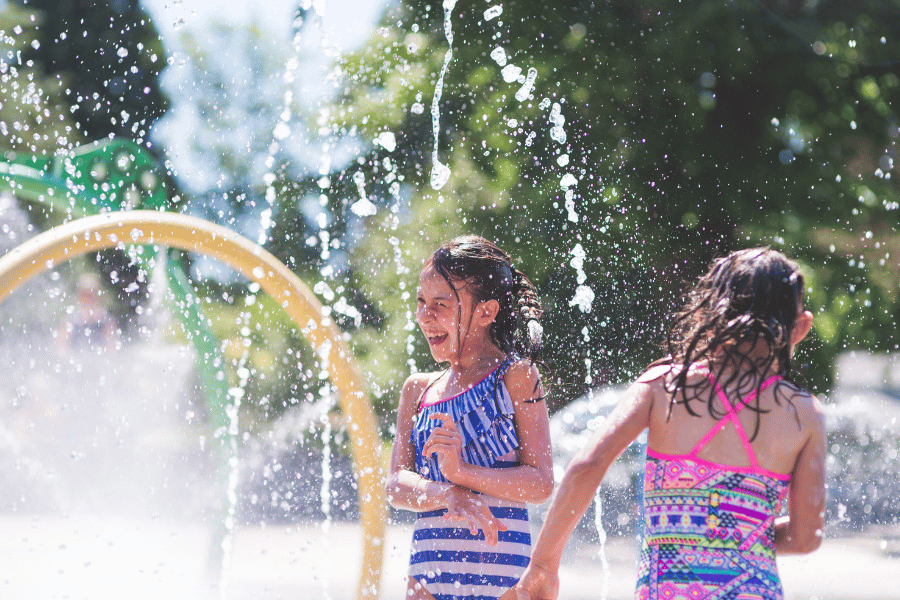 Splash Pad Kids playing in a splash pad on a warm and sunny day