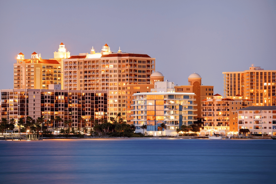 Sarasota, FL skyline at night next to the coast 