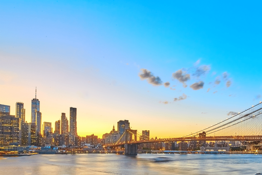 A wide angle photo of the Brooklyn Bridge and New York City