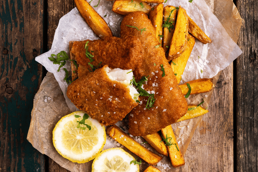 Fish and Chips Image from above of fish and chips with lemons