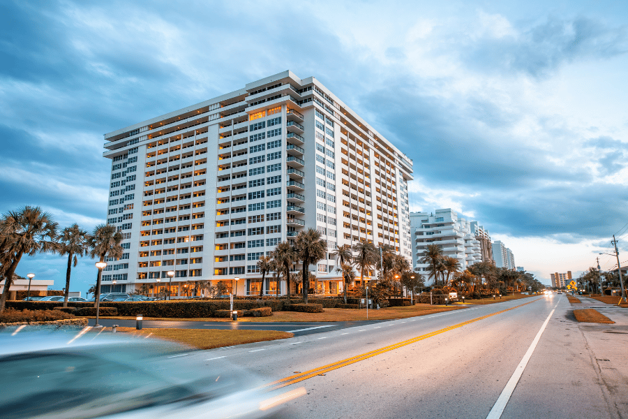 Buildings and palm trees along the street in Boca Raton, FL 