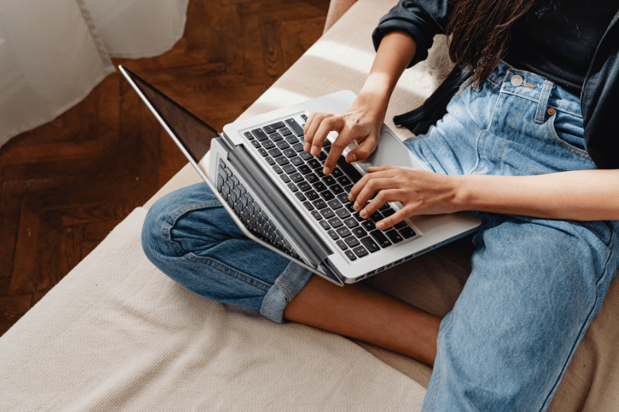 typing on laptop computer on the couch 