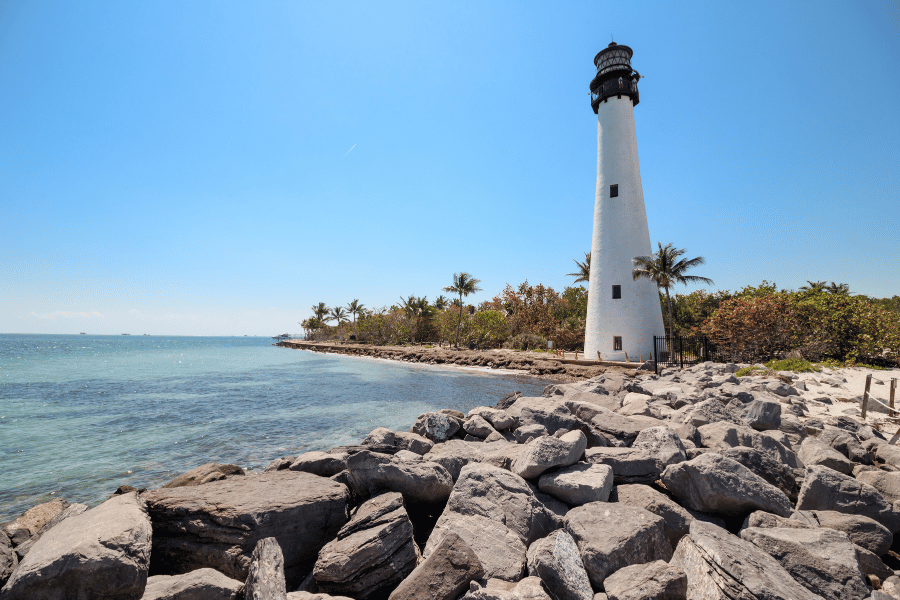 Lighthouse White lighthouse in Key Biscayne, FL near palm trees and rocks